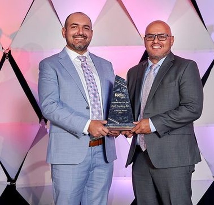 Will Caceres and Gonzalo Caceres, owners of GWC Trucking Inc, accepting recognition from FedEx